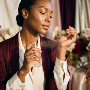 Woman spraying perfume on her wrist — tips to make your perfume last all day